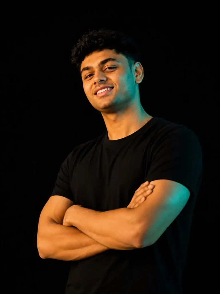Freelance digital marketer smiling with arms crossed against a dark background